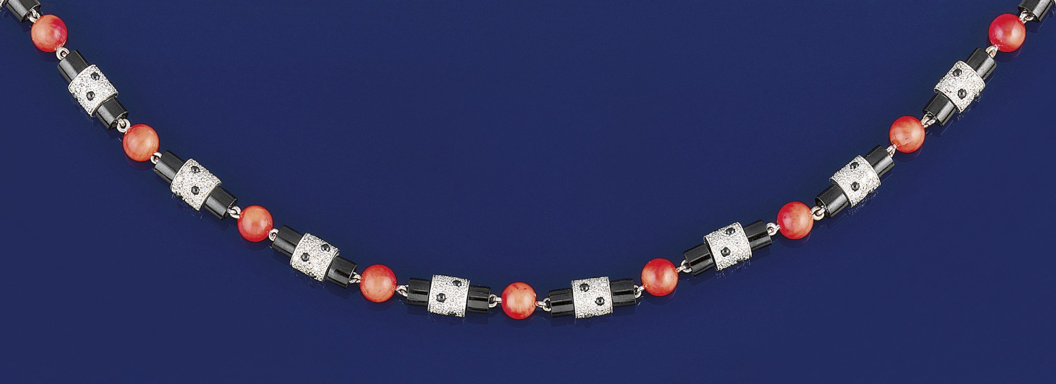 A coral, onyx and diamond necklace