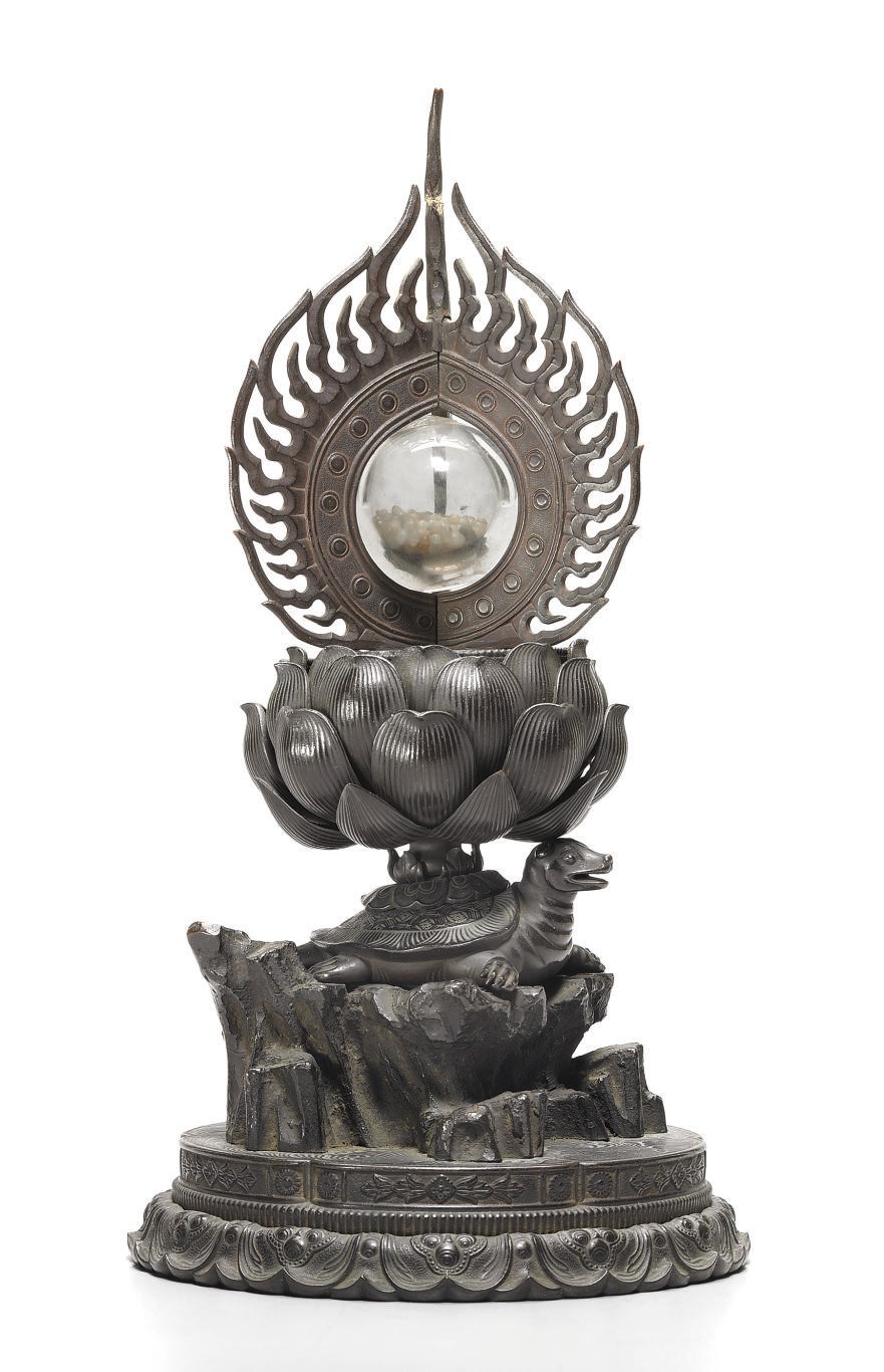 A bronze and crystal reliquary