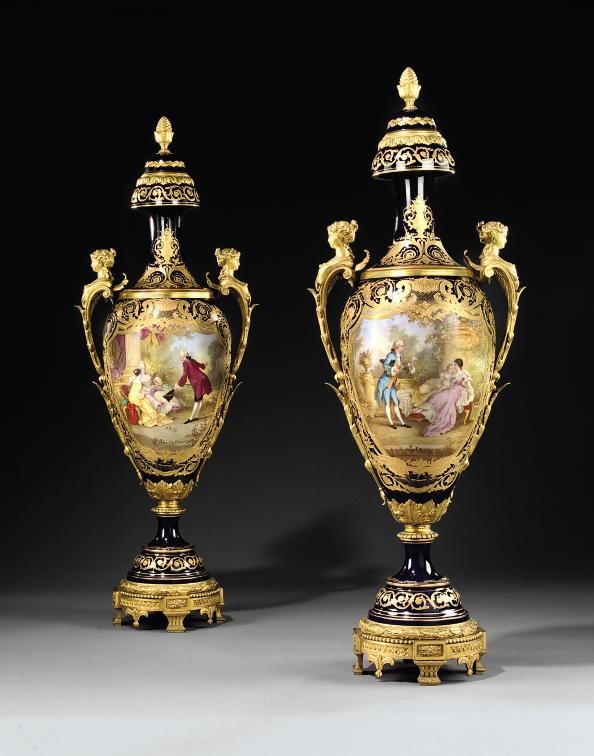 A PAIR OF ORMOLU-MOUNTED SEVRES STYLE COBALT-BLUE GROUND VASES AND COVERS