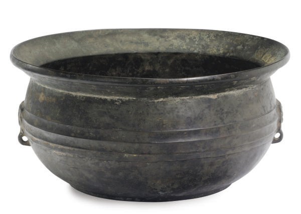 A CHINESE ARCHAIC BRONZE BASIN WITH DESIGNS OF FISH AND COINS MOLDED ON THE INTERIOR,