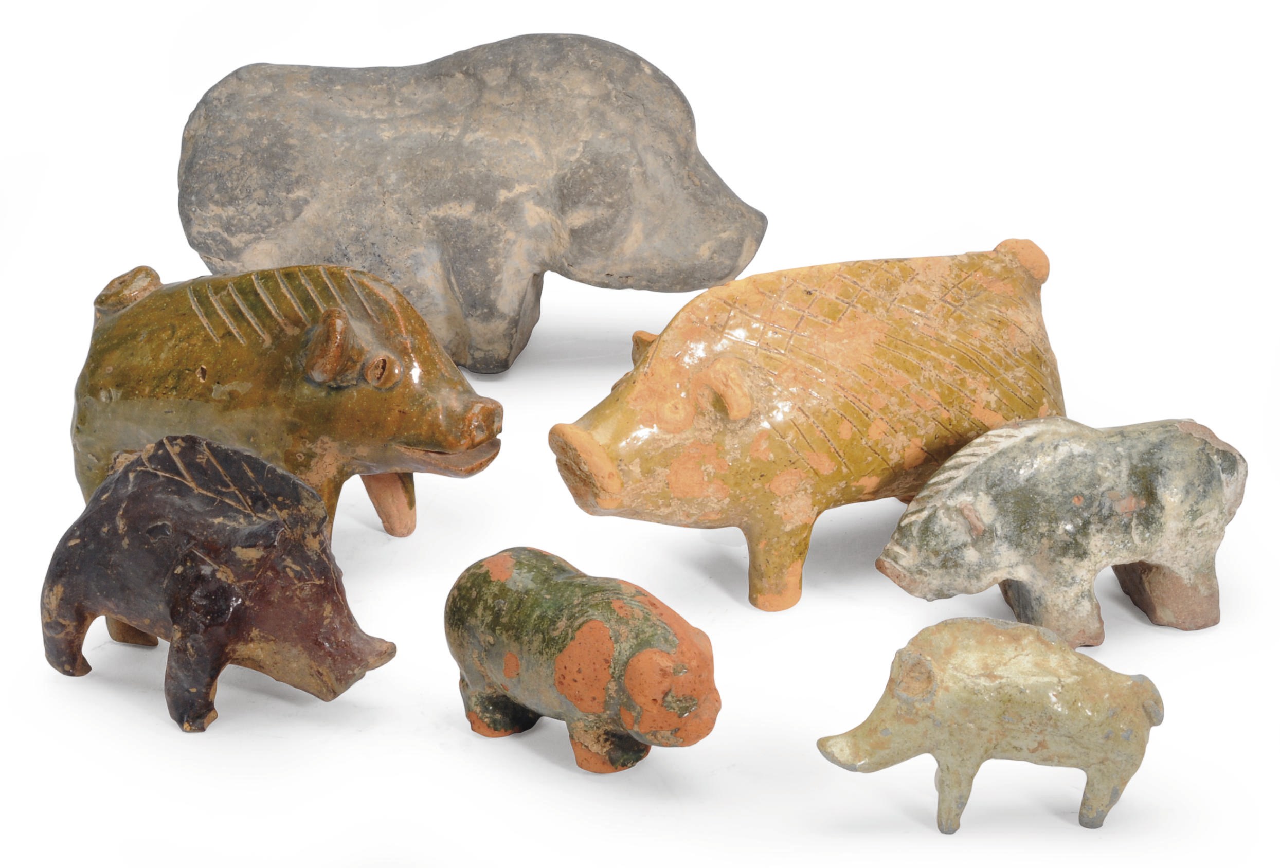 A GROUP OF EIGHT CHINESE PAINTED AND GLAZED POTTERY FIGURES OF PIGS,