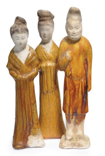 TWO CHINESE AMBER-GLAZED POTTERY FIGURES OF COURT LADIES AND A FIGURE OF A MALE ATTENDANT,