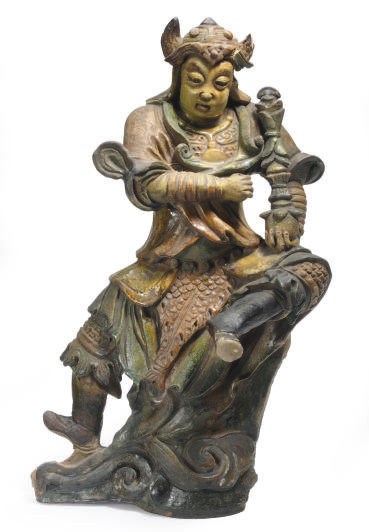 A CHINESE GREEN, AMBER AND BROWN-GLAZED TILEWORKS FIGURE OF AN IMMORTAL IN MILITARY ASPECT,