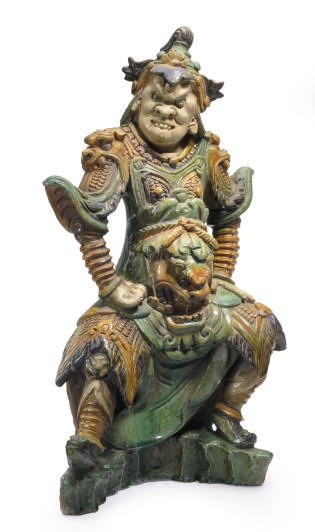 A CHINESE GREEN, AMBER AND AUBERGINE-GLAZED TILEWORKS FIGURE OF AN IMMORTAL IN MILITARY ASPECT,