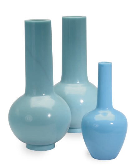 A PAIR OF LARGE PALE BLUE GLASS BOTTLE VASES AND A SMALLER BOTTLE VASE,
