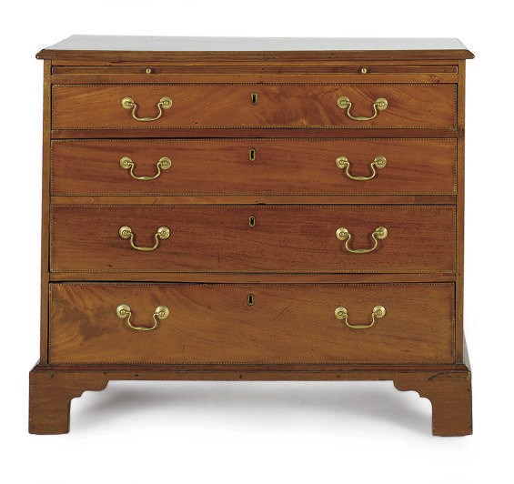 A GEORGE III MAHOGANY AND CHECKER-BANDED CHEST-OF-DRAWERS,