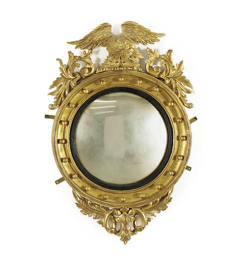 A GILTWOOD AND PART-EBONIZED FIGURAL CONVEX MIRROR,