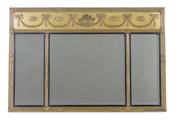 A GILTWOOD AND EBONIZED MIRROR,