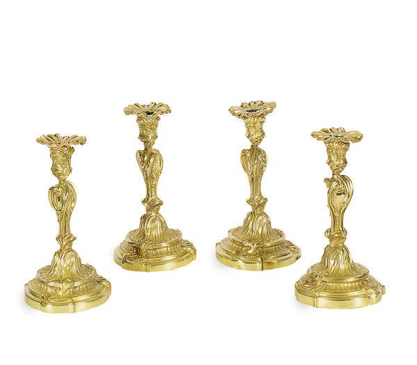 A SET OF FOUR ENGLISH GILT-BRONZE CANDLESTICKS,