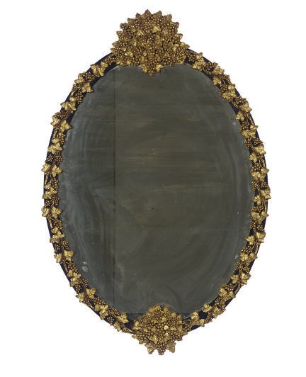 A CONTINENTAL GILTWOOD AND EBONIZED OVAL WALL MIRROR,