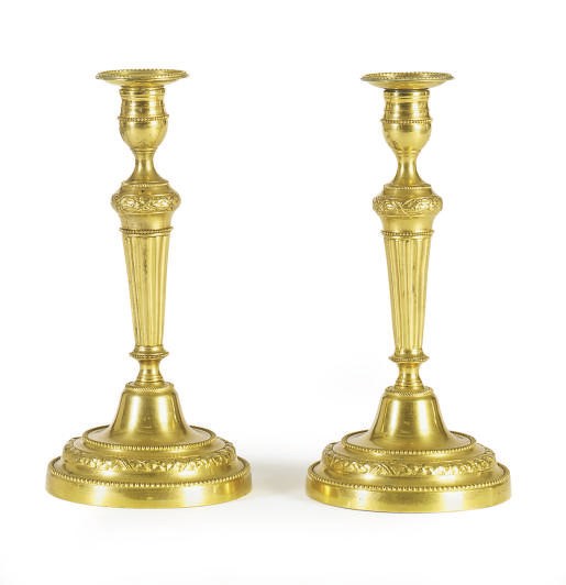 A PAIR OF GILT-METAL CANDLESTICKS,