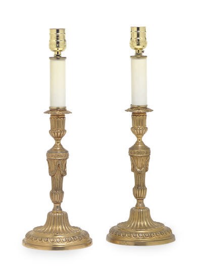 A PAIR OF GILT-BRONZE CANDLESTICKS MOUNTED AS LAMPS,