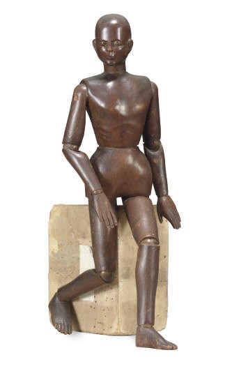 A STAINED WOOD ARTICULATED FIGURE,