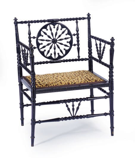 A VICTORIAN EBONIZED ARMCHAIR,