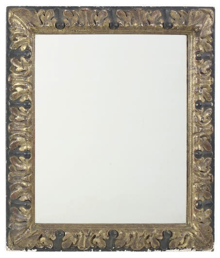 A CONTINENTAL EBONIZED AND PARCEL-GILT MIRROR