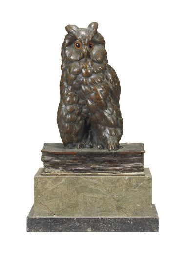 A PATINATED BRONZE FIGURE OF AN OWL ON BOOK,