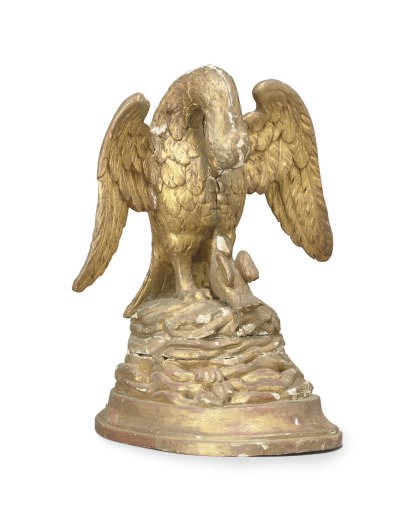 A CONTINENTAL GILTWOOD FIGURE OF AN EAGLE,