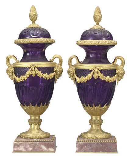 A PAIR OF GILT-BRONZE MOUNTED AMETHYST-COLORED GLASS URNS WITH COVERS,