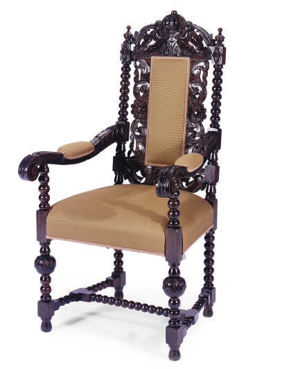 A STAINED AND CARVED OAK ARMCHAIR,