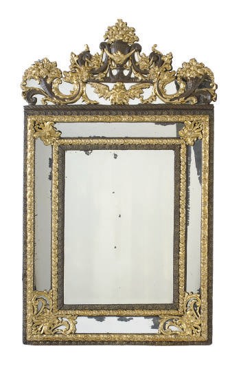 A CONTINENTAL PATINATED AND GILT-METAL REPOUSSE-MOUNTED MIRROR,