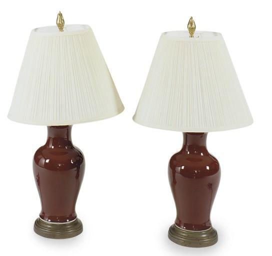 A PAIR OF CHINESE SANG DU BOEUF VASES MOUNTED AS LAMPS