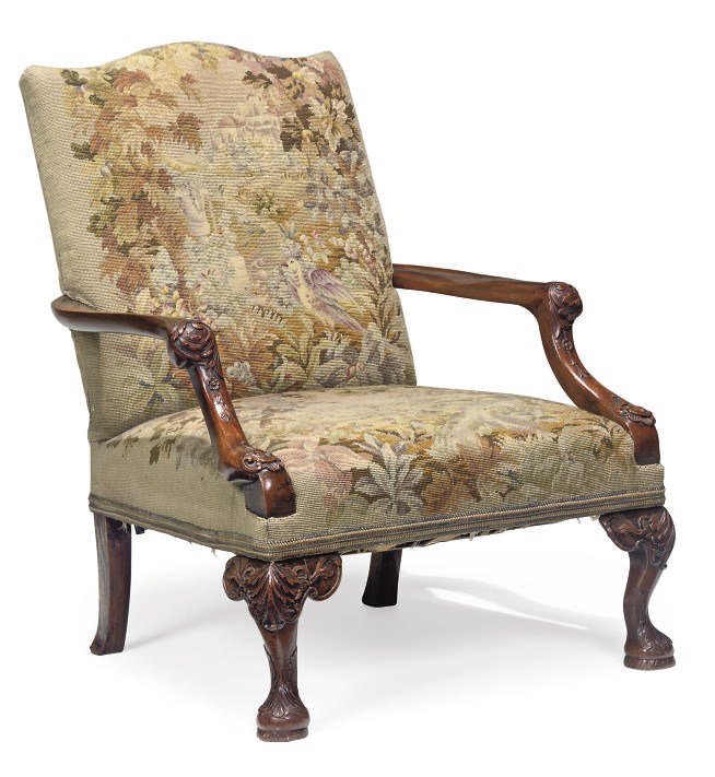 A CARVED MAHOGANY LIBRARY ARMCHAIR