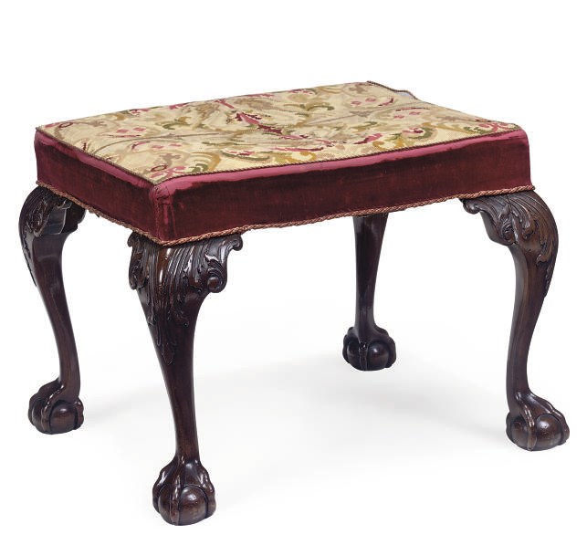 AN EDWARDIAN MAHOGANY CARVED STOOL