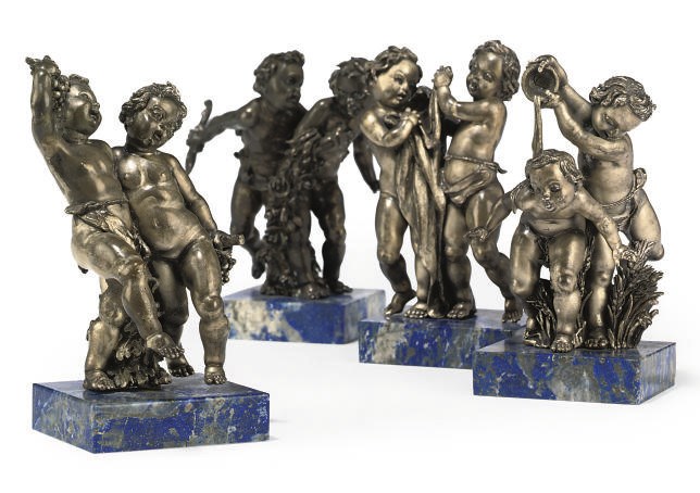 A SET OF FOUR CONTINENTAL SILVERED PUTTO GROUPS EMBLEMATIC OF THE SEASONS