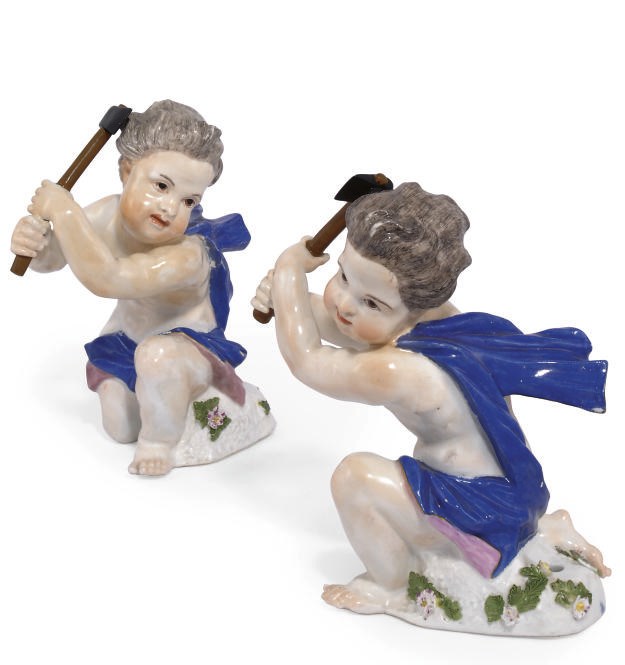 TWO MEISSEN FIGURES OF A PUTTO WIELDING AN AXE
