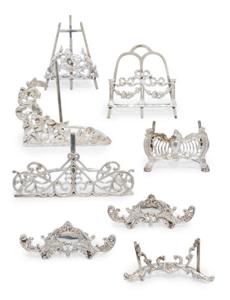A GROUP OF EIGHT LATE VICTORIAN/EDWARDIAN DECORATIVE SILVER MENU HOLDERS