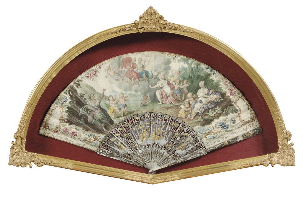 A PARCEL-GILT AND SILVERED MOTHER-OF-PEARL FAN PAINTED WITH A MYTHOLOGICAL SCENE