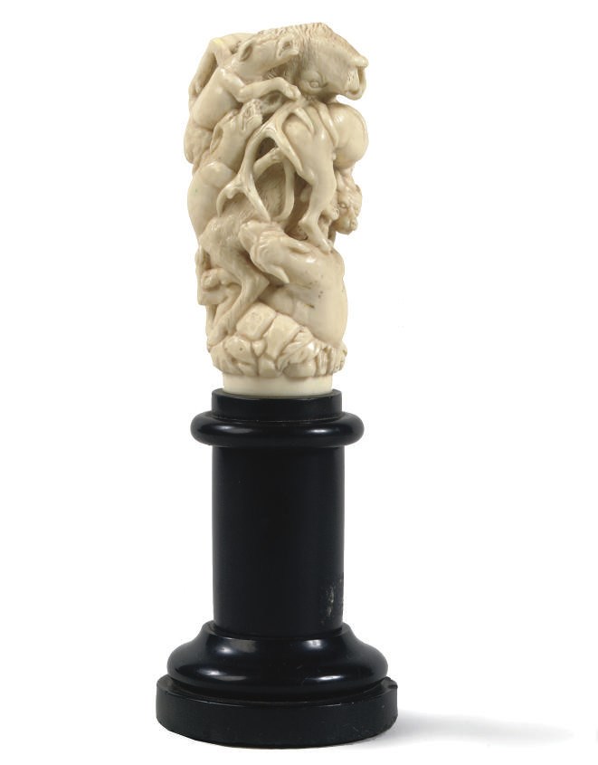 A CARVED IVORY GROUP OF HOUNDS ATTACKING A STAG