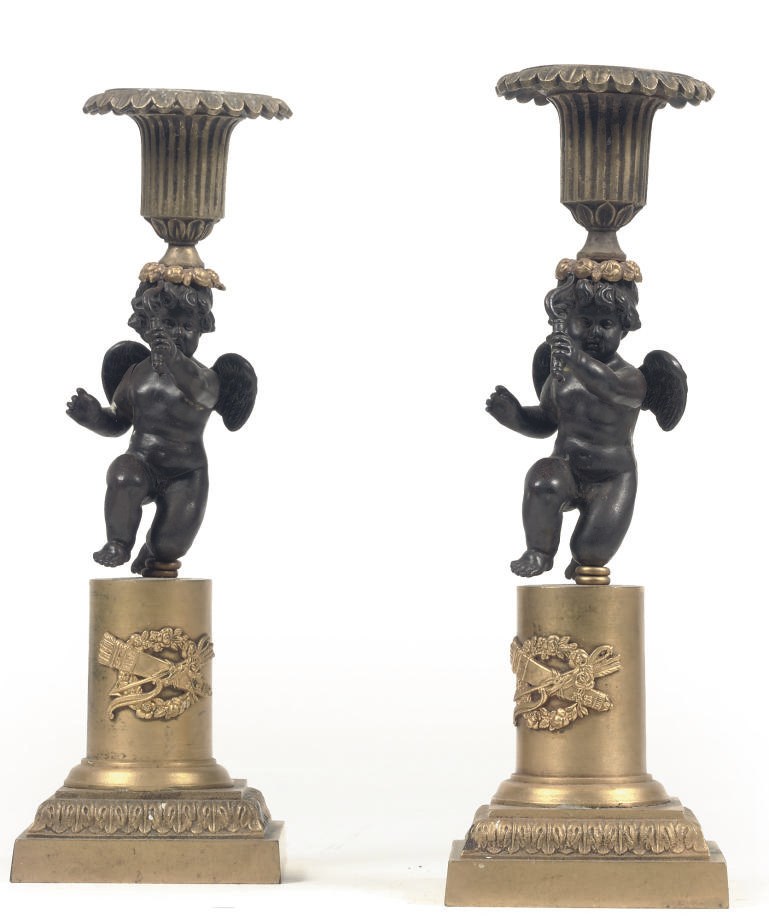 A PAIR OF NORTH EUROPEAN PARCEL-GILT AND CAST-IRON FIGURAL CANDLESTICKS