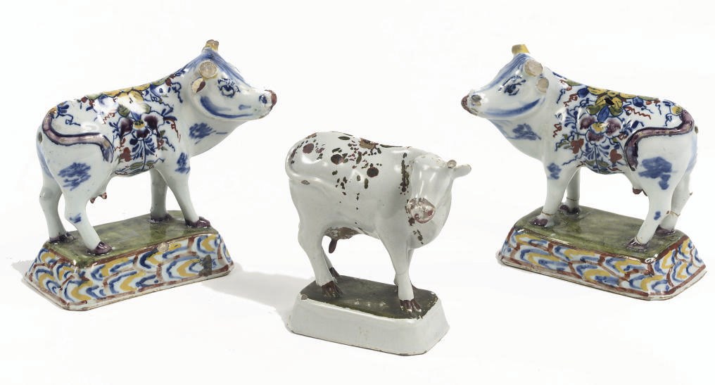 A pair and one Dutch Delft models of standing cows