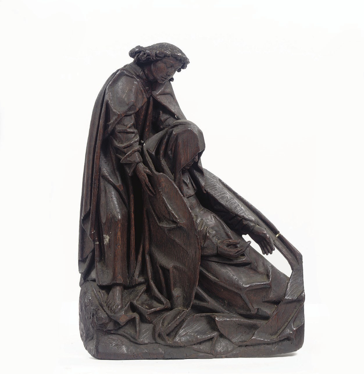 A CARVED OAK GROUP OF THE SWOONING OF THE VIRGIN