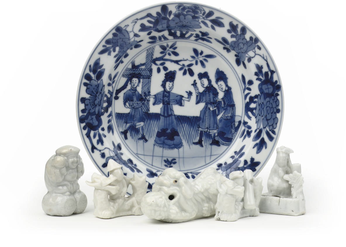 A Chinese blue and white small dish and five blanc-de-chine miniature figures