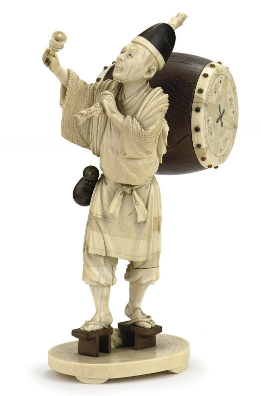 A Japanese ivory and wood okimono of an entertainer