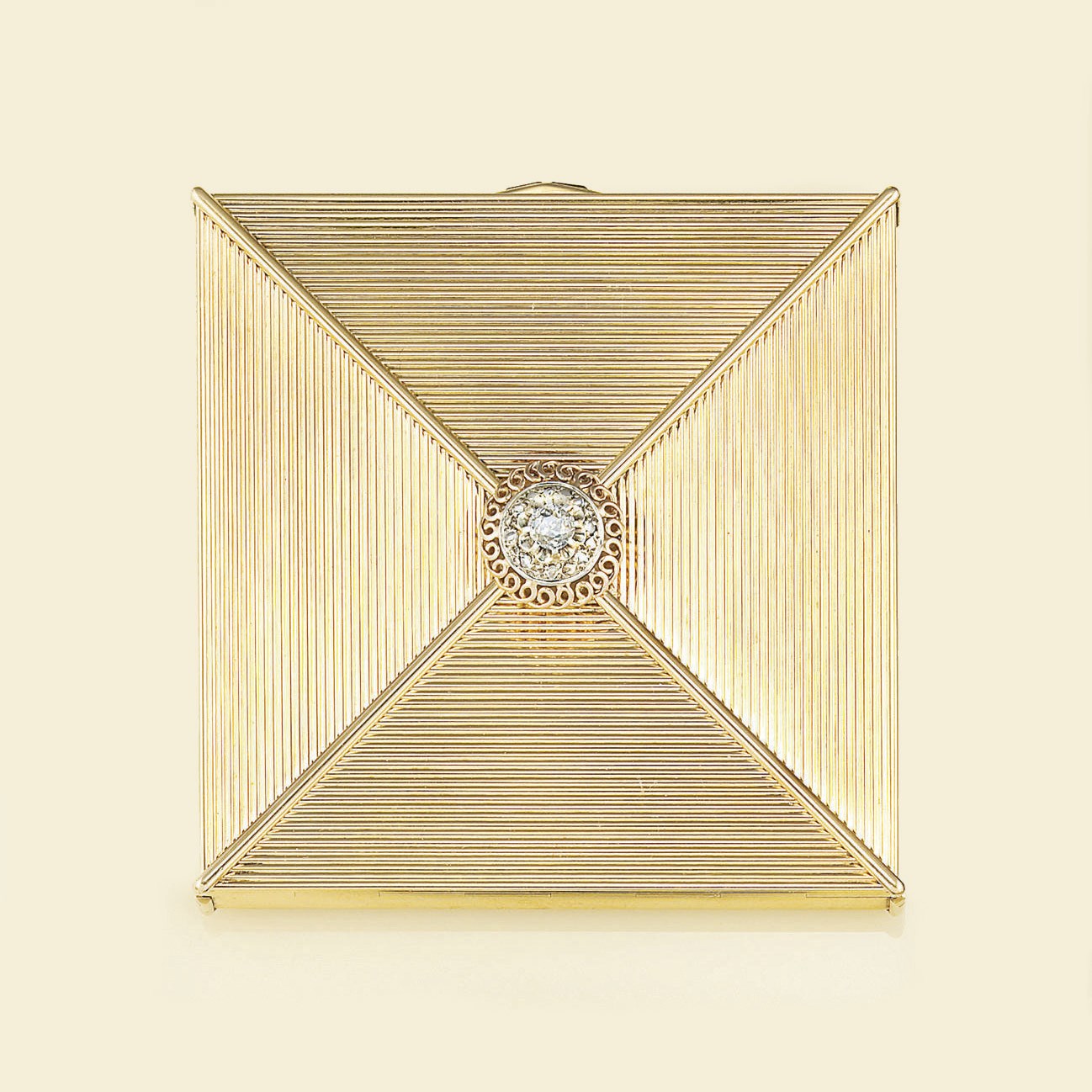 A diamond and ruby set compact, by Cartier