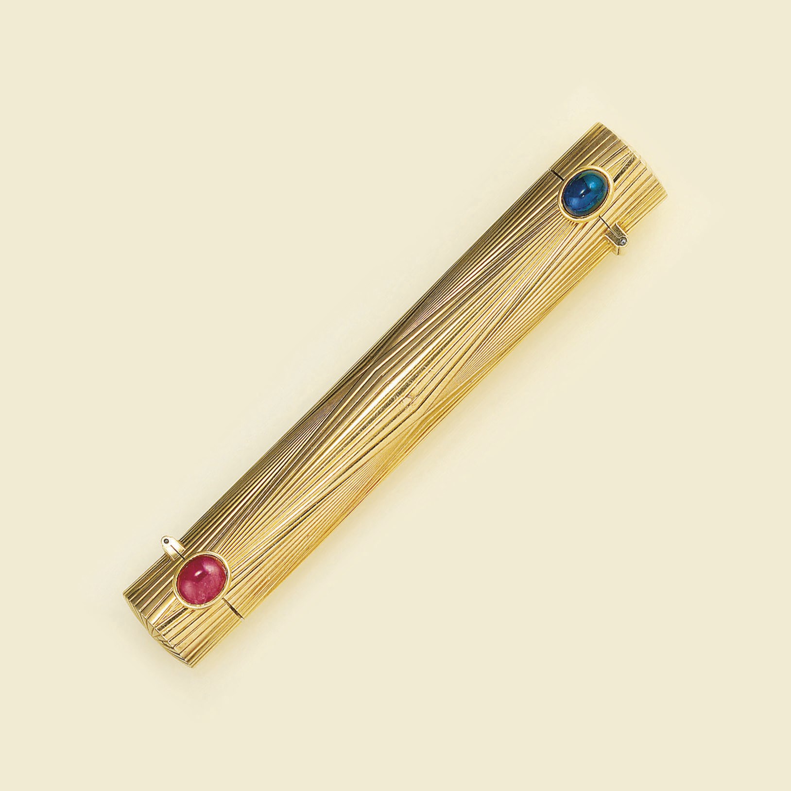 A sapphire and ruby set twin lipstick holder, by Cartier