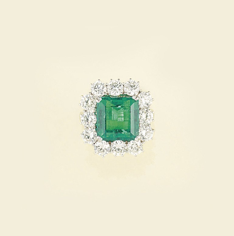 An emerald and diamond cluster ring