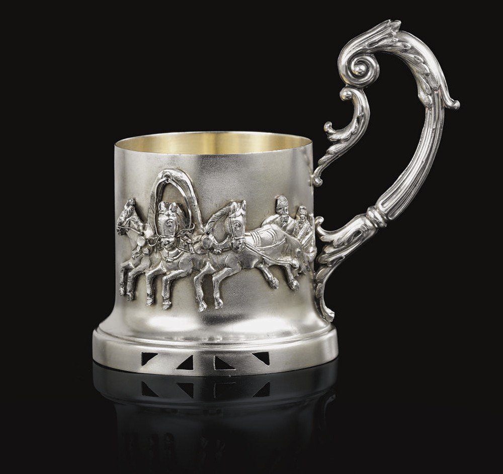 A SILVER TEA GLASS HOLDER
