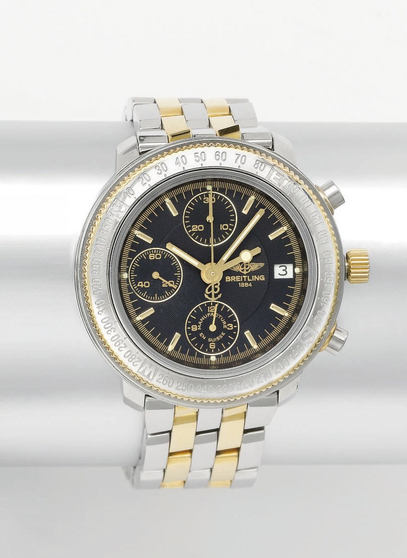 Breitling. A stainless steel and gold automatic dual time chronograph wristwatch with date and bracelet