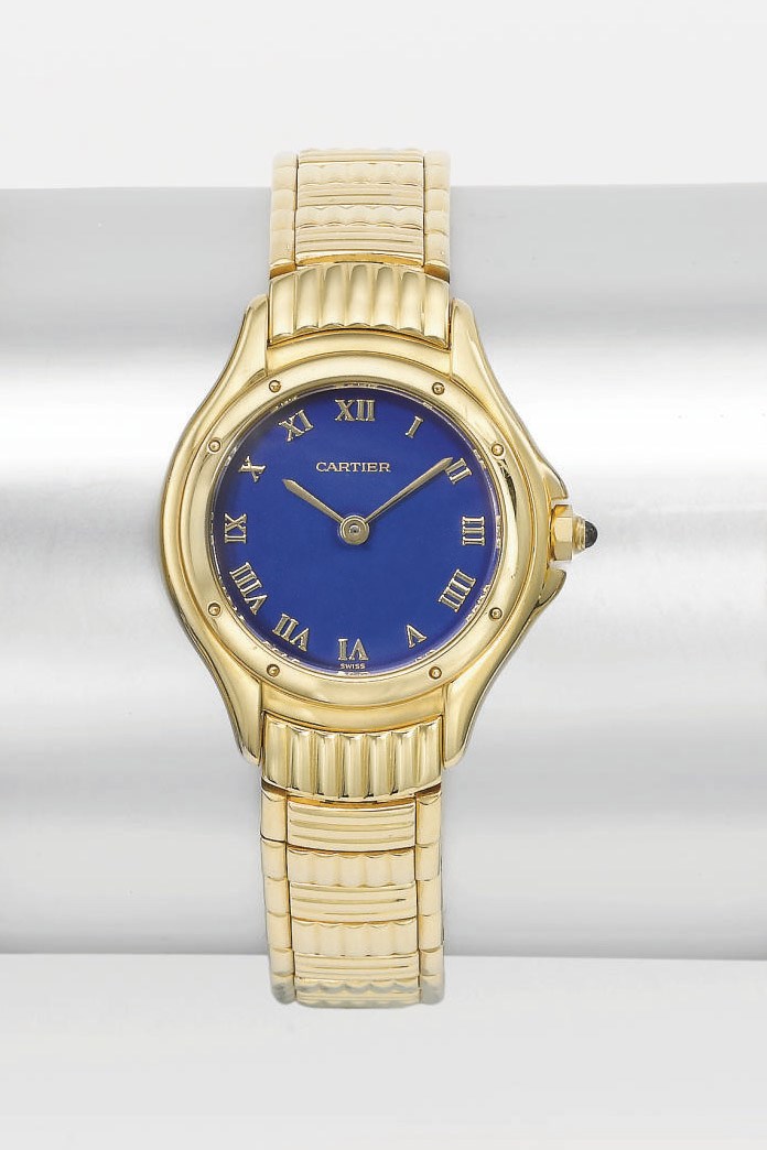 Cartier. A lady's 18K gold tonneau-shaped wristwatch bracelet