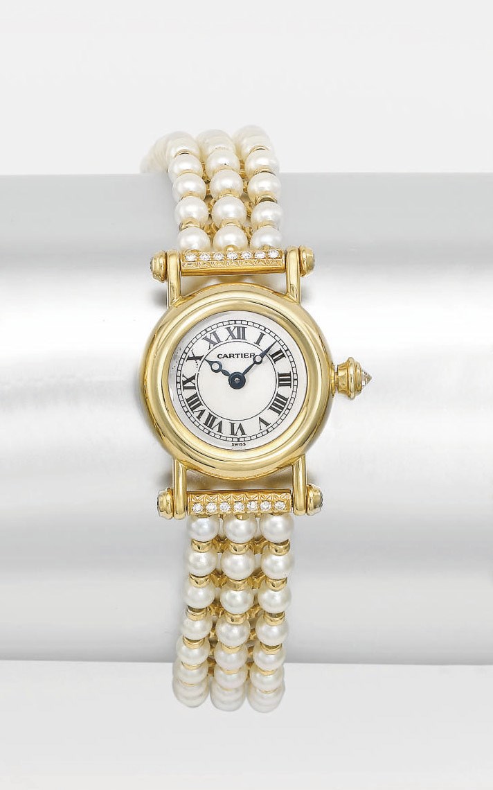 Cartier. A lady's fine 18K gold and diamond-set wristwatch with mother-of-pearl dial and pearl bracelet