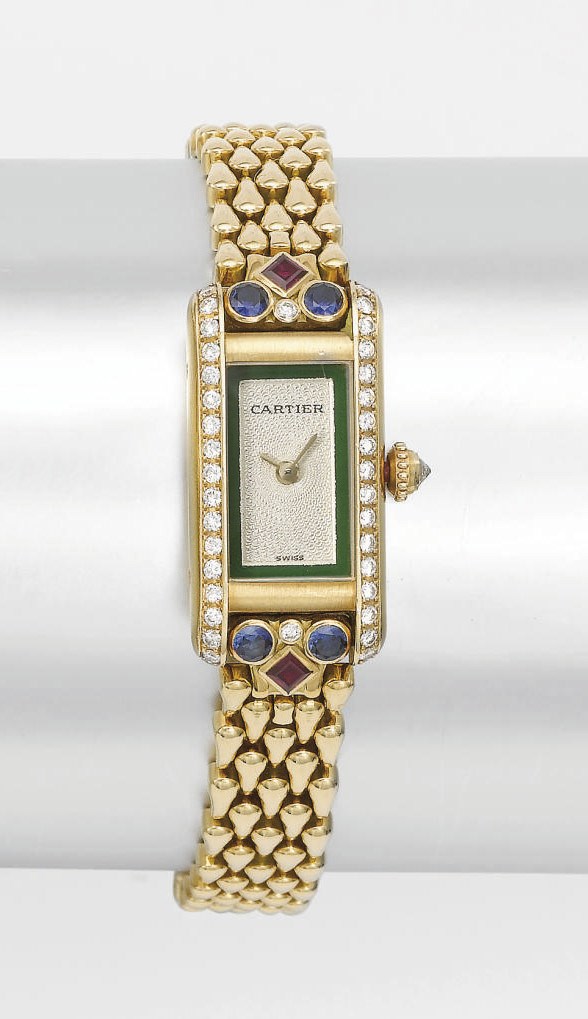 Cartier. A lady's fine 18K gold, diamond, sapphire and ruby-set rectangular wristwatch with bracelet