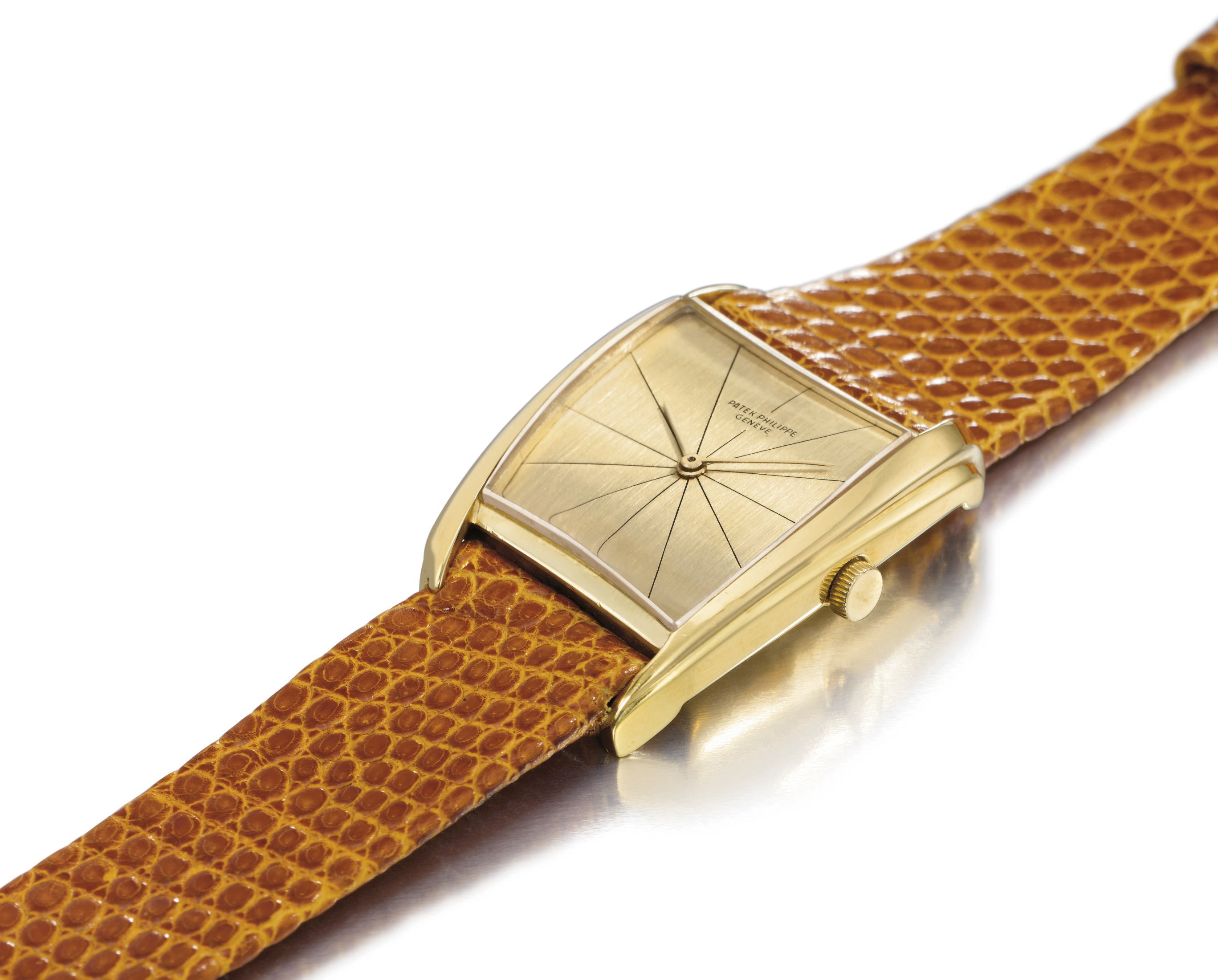 Patek Philippe. An extremely fine and rare 18K gold asymmetrical wristwatch with champagne dial, designed by Gilbert Albert