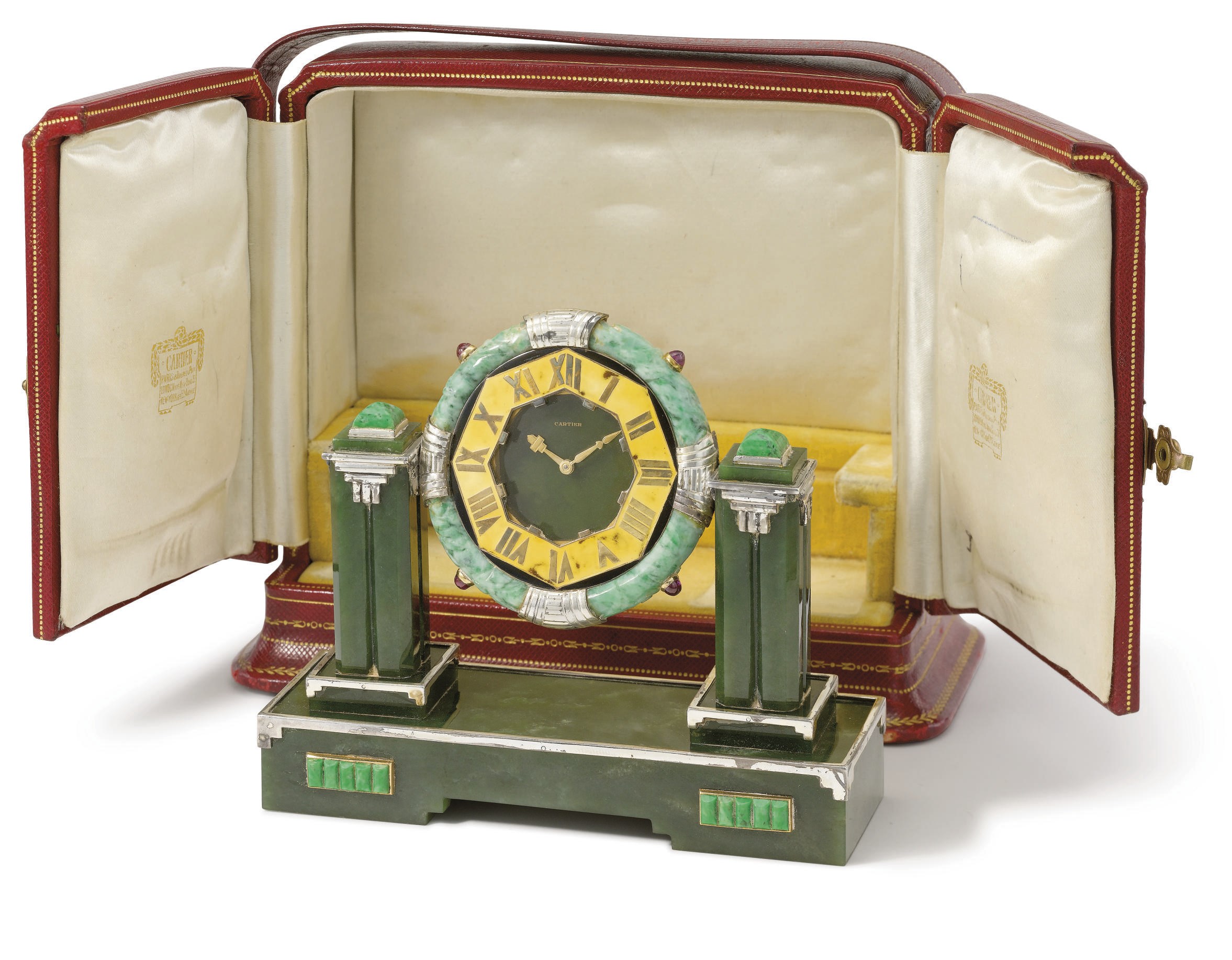 Cartier. A fine, rare and unusual silver, jadeite, nephrite, enamel and ruby-set Art Deco desk timepiece with original box