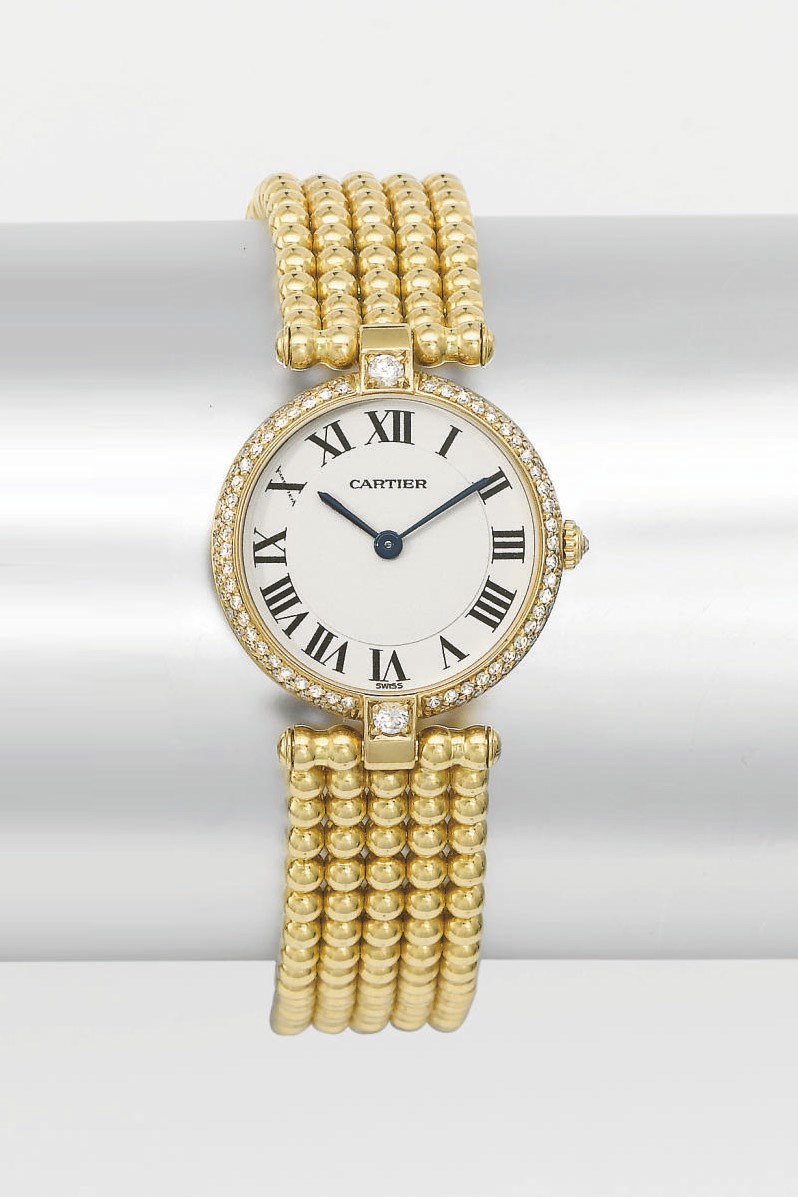 Cartier. A lady's 18K gold and diamond-set wristwatch with bracelet