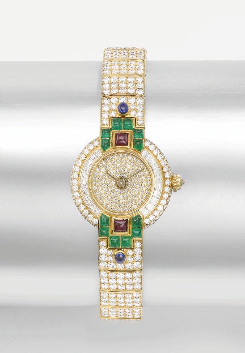 Cartier. A lady's fine 18K gold, diamond, ruby, emerald and sapphire-set wristwatch with bracelet