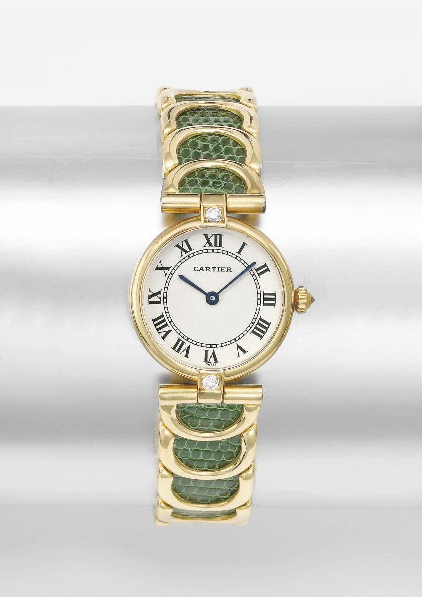 Cartier. A lady's 18K gold and diamond-set wristwatch with gold and leather bracelet